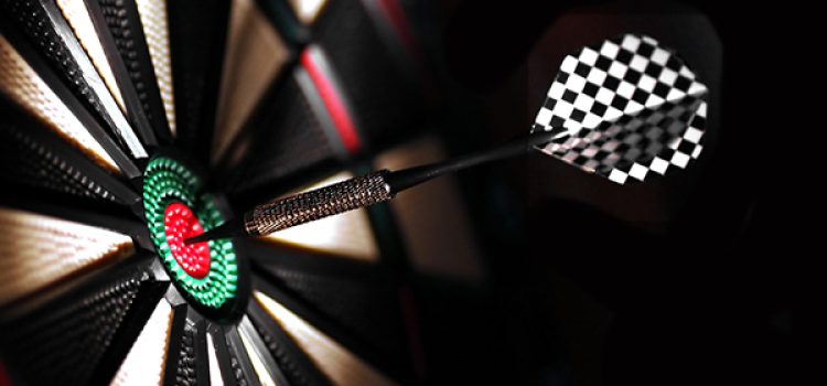 One arrow in the centre of a dart board. Shallow depth of field