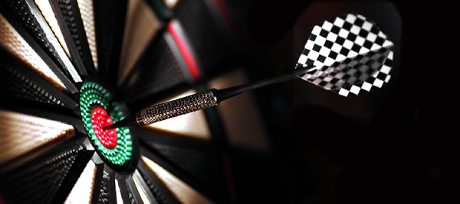 One arrow in the centre of a dart board. Shallow depth of field