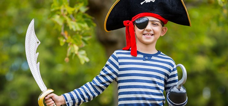 Portrait of boy pretending to be a pirate in the park