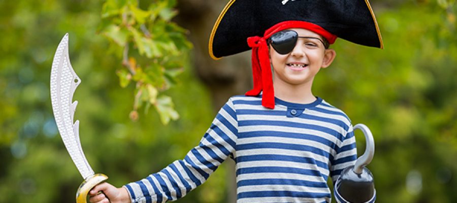 Portrait of boy pretending to be a pirate in the park